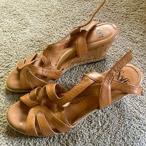 Women’s tan wedges with adjustable buckle sling.